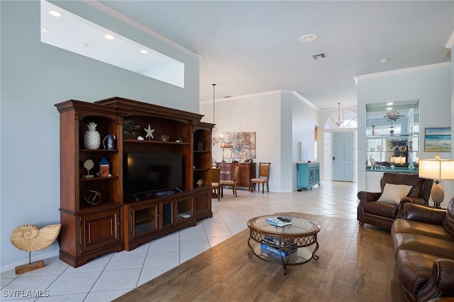 living room featuring light wood-type flooring and crown molding