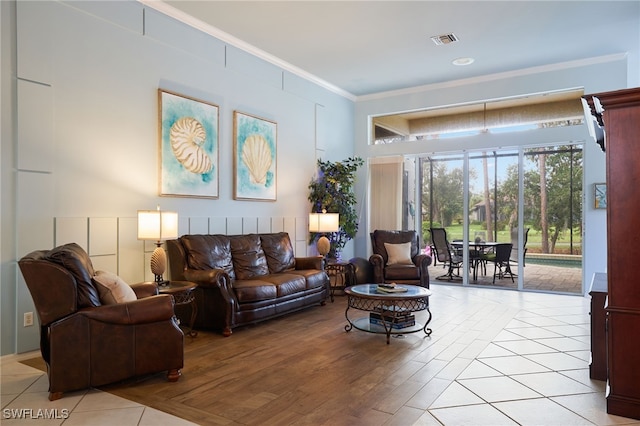 living room with light wood-type flooring and ornamental molding