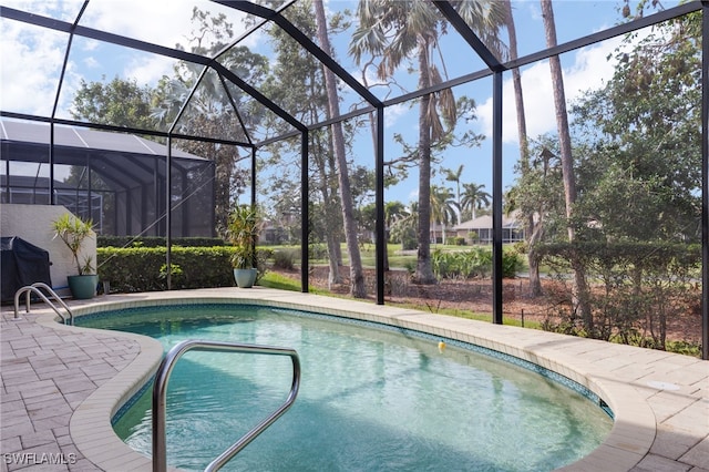 view of swimming pool with a lanai and a patio