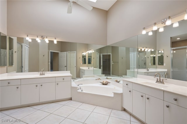 bathroom featuring vanity, ceiling fan, tile patterned floors, and a skylight