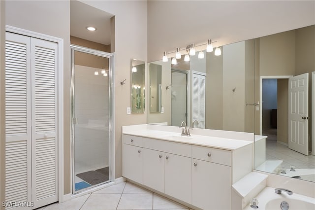 bathroom featuring tile patterned flooring, an enclosed shower, and vanity