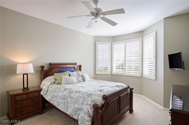 bedroom featuring ceiling fan and light carpet