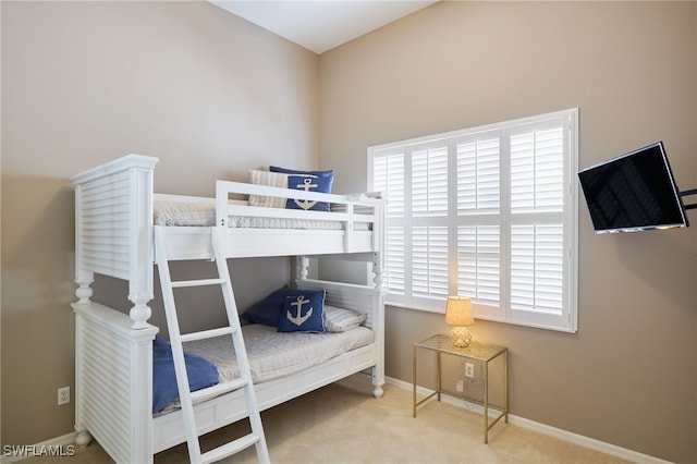 carpeted bedroom with multiple windows