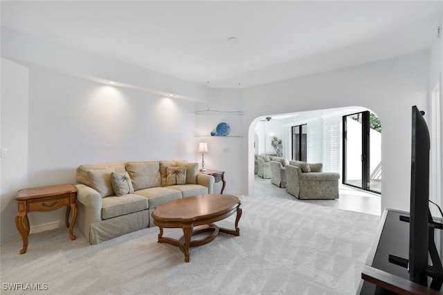 2233 Anchorage Ln Unit B, Naples, FL 34104 - living area with arched walkways, light colored carpet, and baseboards