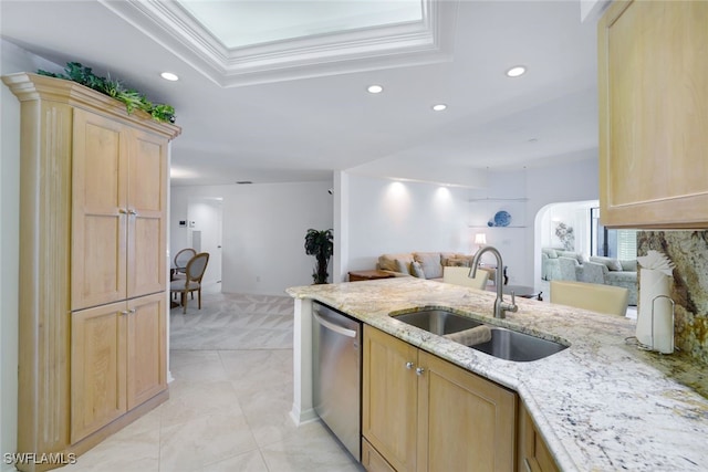 kitchen with dishwasher, sink, light stone counters, crown molding, and light brown cabinetry