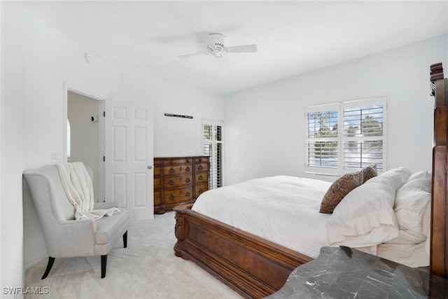 bedroom with ceiling fan and light colored carpet