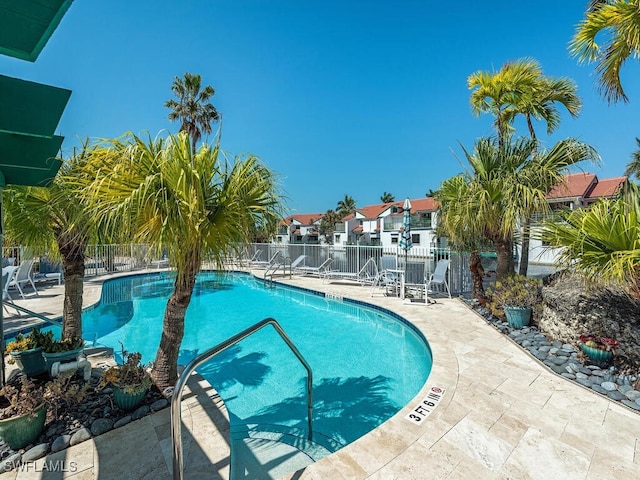 2233 Anchorage Ln Unit B, Naples, FL 34104 - community pool with a patio and a residential view