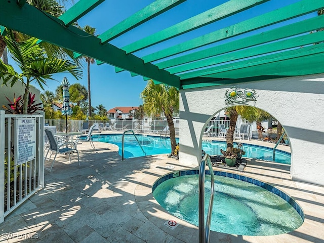 view of pool featuring a patio and a hot tub