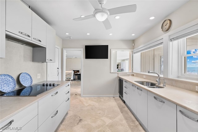 kitchen featuring ceiling fan, beverage cooler, white cabinetry, and sink