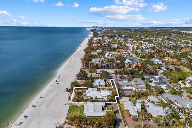 drone / aerial view with a water view and a beach view