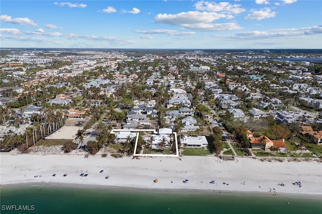 drone / aerial view featuring a view of the beach and a water view