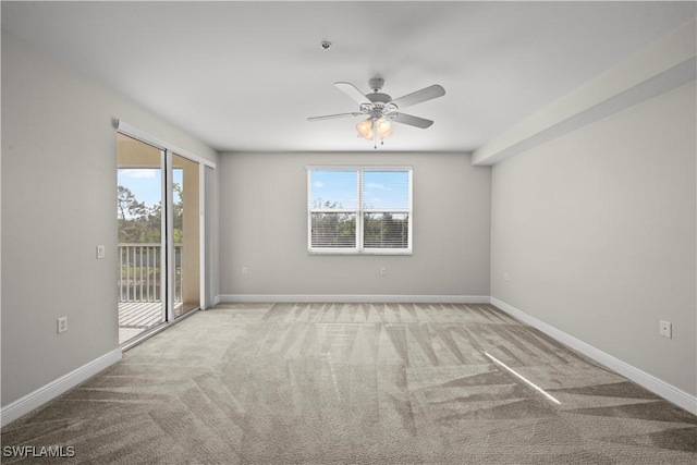 spare room featuring ceiling fan and light colored carpet