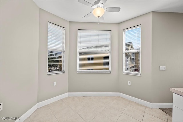 tiled empty room with ceiling fan