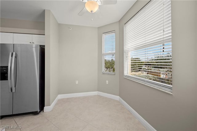 kitchen featuring ceiling fan, white cabinetry, stainless steel fridge with ice dispenser, and light tile patterned floors