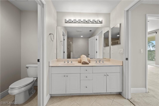 bathroom featuring tile patterned flooring, vanity, and toilet