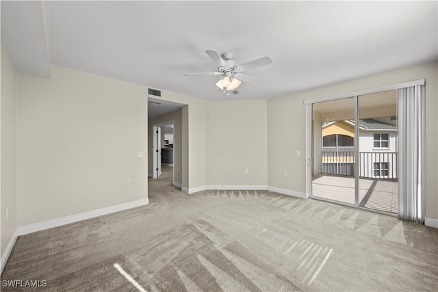 carpeted spare room featuring ceiling fan