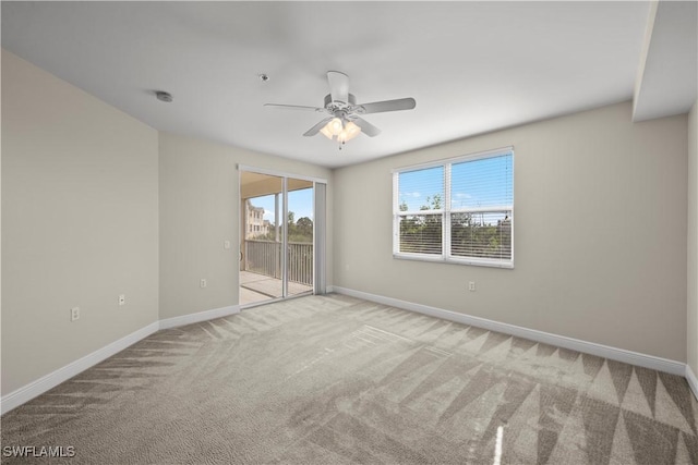 carpeted empty room featuring ceiling fan