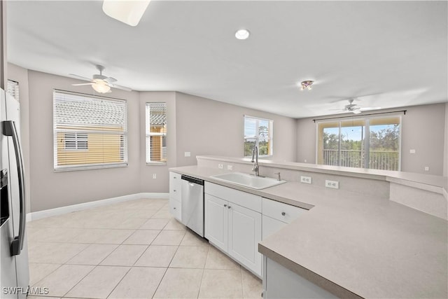 kitchen with ceiling fan, sink, light tile patterned flooring, white cabinets, and appliances with stainless steel finishes