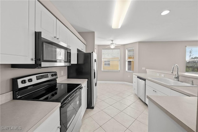 kitchen with ceiling fan, sink, light tile patterned floors, white cabinets, and appliances with stainless steel finishes