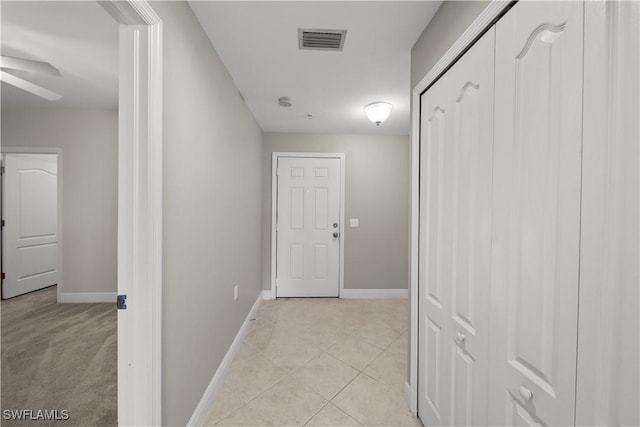 corridor with light tile patterned floors