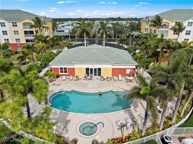 view of swimming pool with a patio area and a hot tub