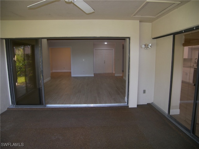 interior space with ceiling fan