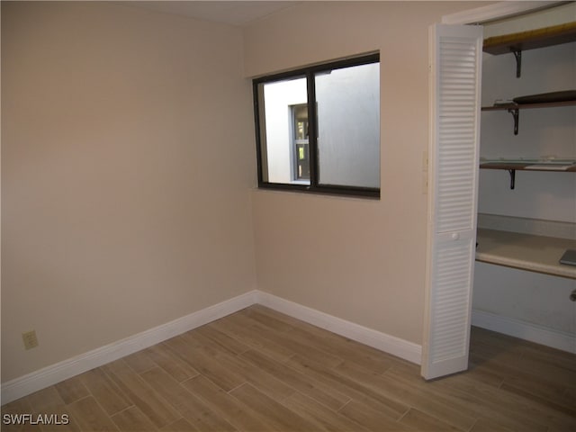 unfurnished bedroom featuring light wood-type flooring and a closet