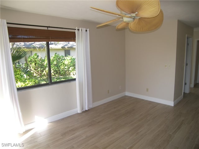 unfurnished room with ceiling fan and wood-type flooring