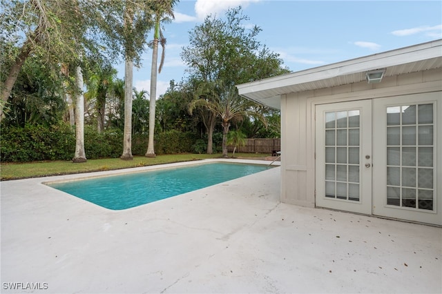 view of swimming pool featuring french doors and a patio