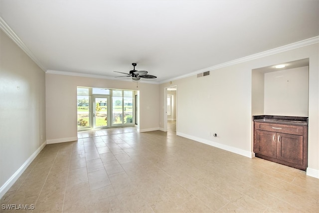 spare room with ornamental molding and ceiling fan