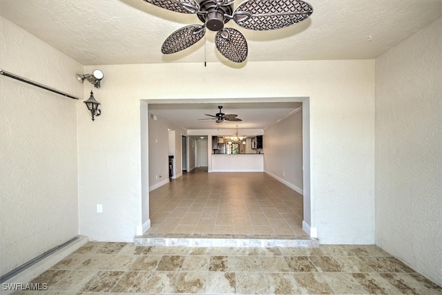 empty room with ceiling fan with notable chandelier and ornamental molding