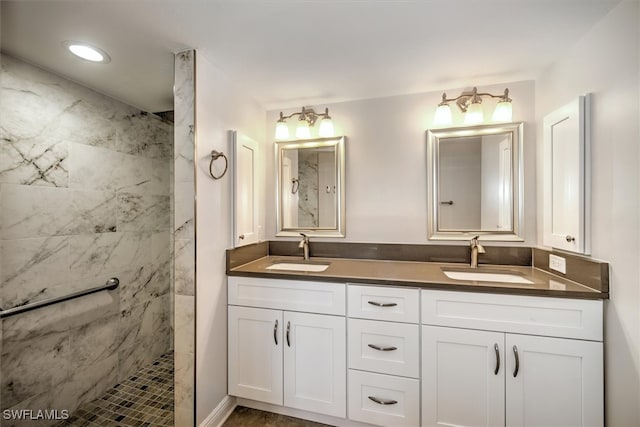 bathroom featuring vanity and tiled shower