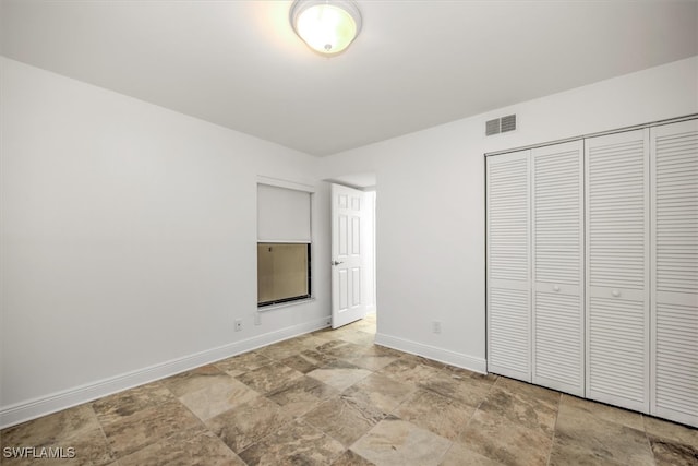 unfurnished bedroom with a closet