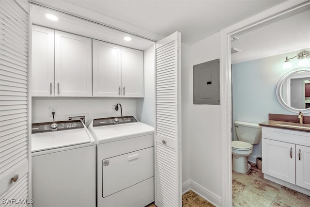 clothes washing area featuring electric panel, independent washer and dryer, cabinets, and sink