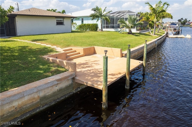 dock area featuring a lanai, a yard, and a water view