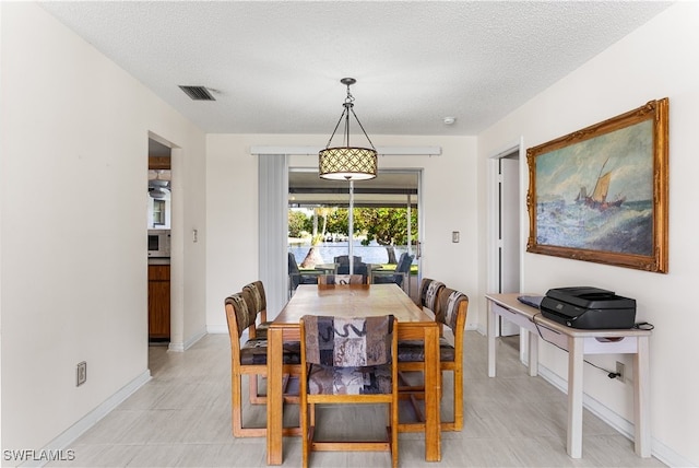 dining room with a textured ceiling