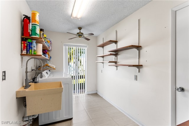 laundry area with a textured ceiling, ceiling fan, and washing machine and clothes dryer