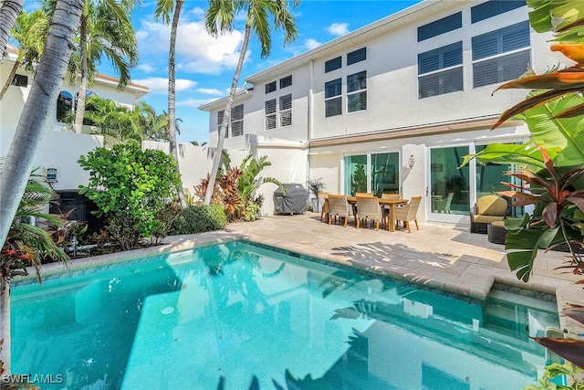 view of swimming pool with grilling area and a patio area