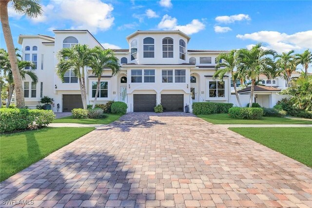 mediterranean / spanish house with a garage and a front yard