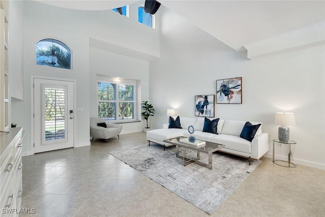 living room featuring tile patterned floors and high vaulted ceiling