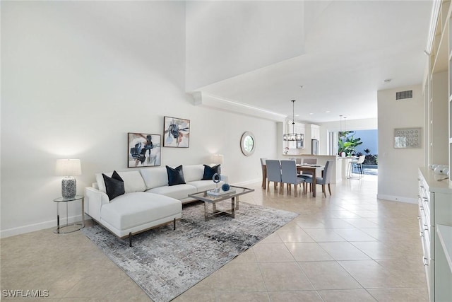 living room featuring light tile patterned flooring and a towering ceiling