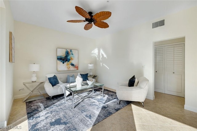 living room with ceiling fan and light tile patterned floors