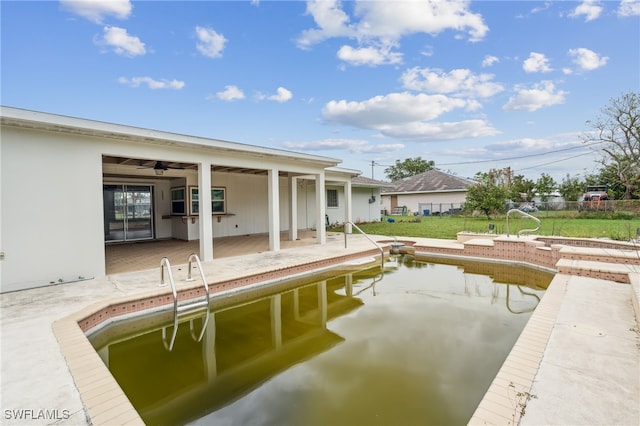 view of pool featuring ceiling fan and a patio area