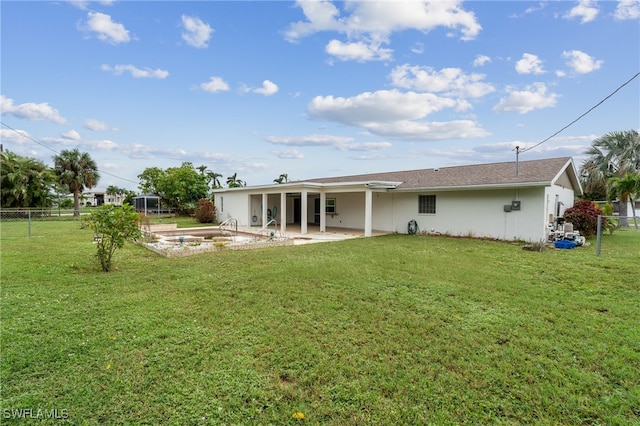 back of property featuring a patio and a yard