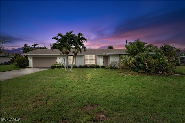 ranch-style house with a lawn and a garage