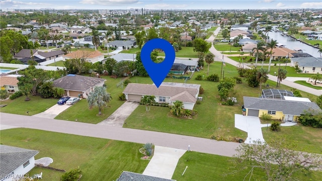 birds eye view of property with a water view