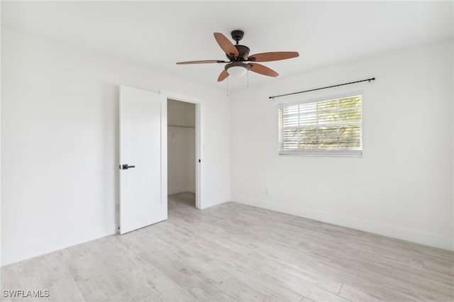 spare room featuring light hardwood / wood-style flooring and ceiling fan