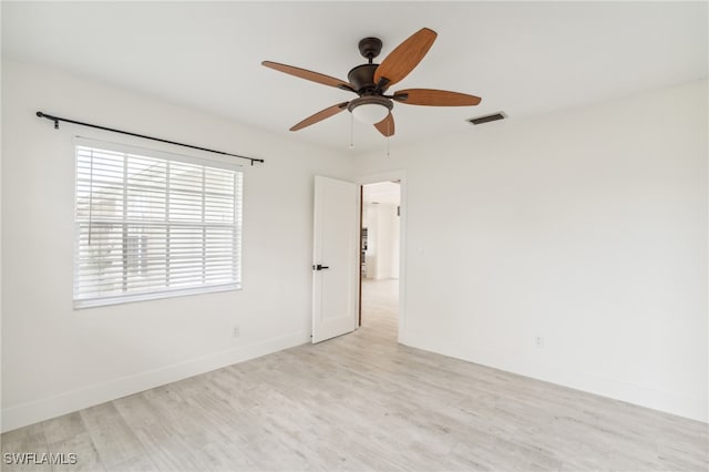 empty room with light hardwood / wood-style flooring and ceiling fan