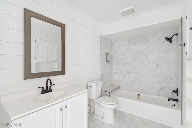 full bathroom with toilet, vanity, tiled shower / bath, and wooden walls