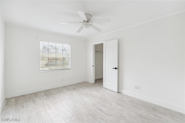 spare room with ornamental molding, light hardwood / wood-style floors, and ceiling fan